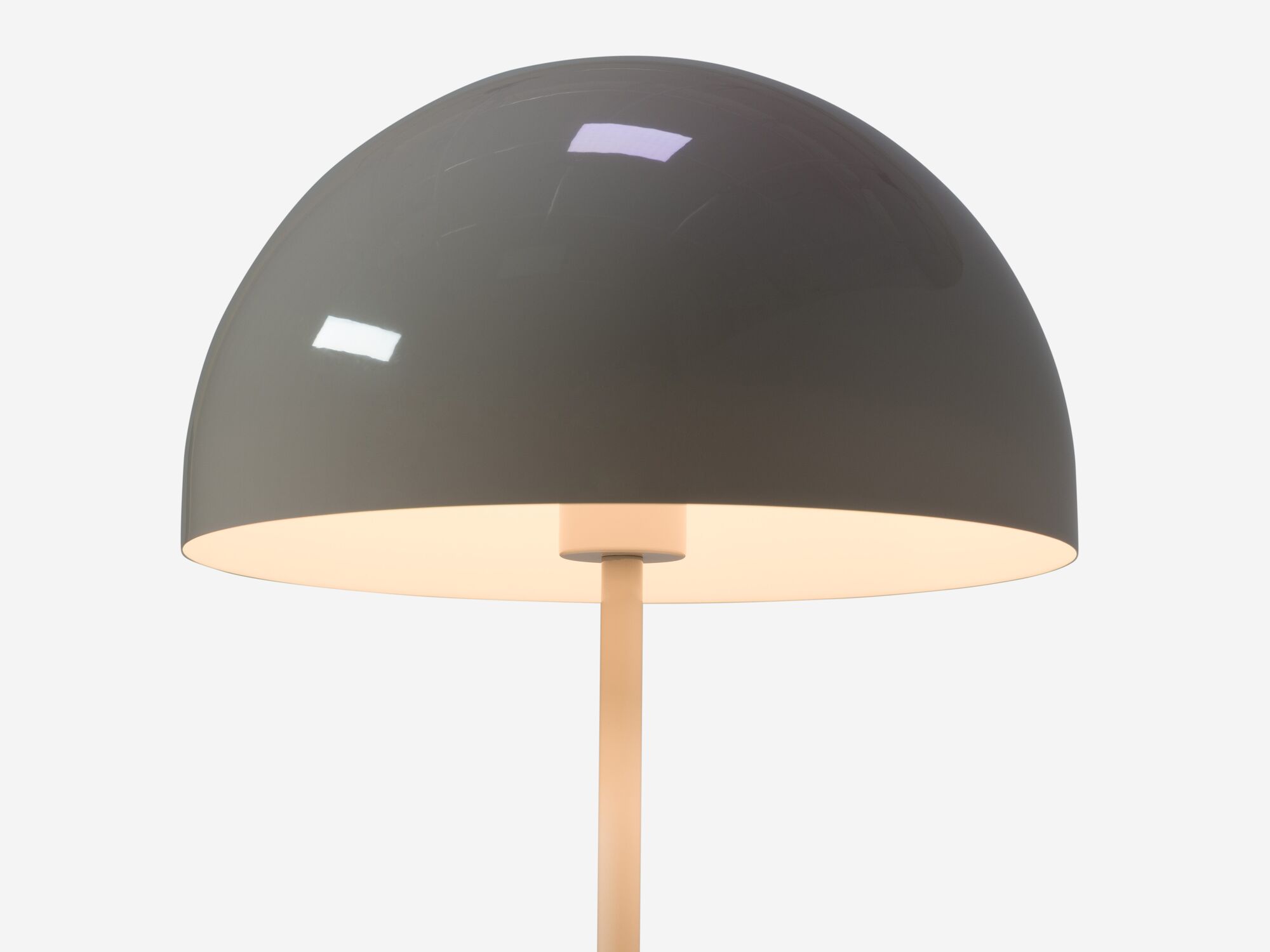 Detail view of round grey table lamp shade with light on